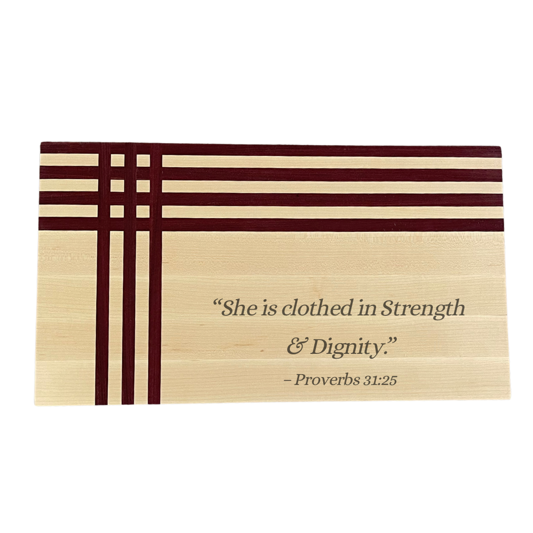 Maple and purpleheart board engraved with She Is Clothed in Strength and Dignity Proverbs 31:25